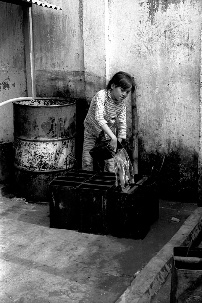 Girl filling water in Saigon
