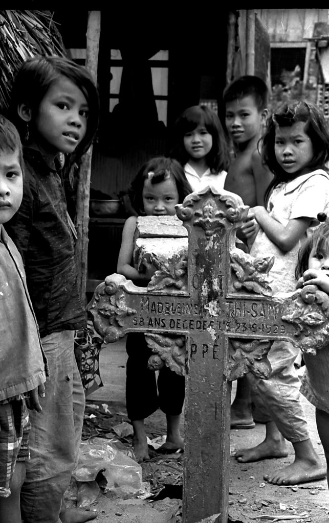 Kids standing  around cross