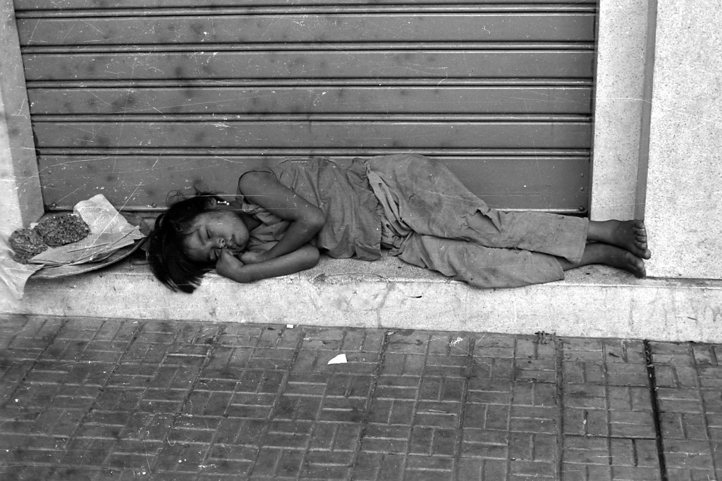 Girl sleeping on the street in Saigon